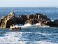 The inshore rescue boat next to the rocks - photo by Tony Rive