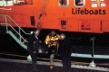 A Wheel retrived from the Sea from a ditched light Aircraft being handed to the Deputy Harbour Master from a Lifeboatman in Guernsey 12-11-11 Pic by Tony Rive