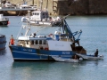 Pic by Tony Rive 17-09-15 Two Guernsey Harbour Marina Staff member's manouvre their Dories to berth the local Fishing boat Defiance alongside the East side of the Fish Quay in St Peter Port after it had been towed home by the Lifeboat Spirit of Guernsey.