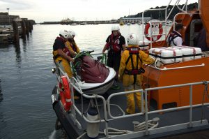 Pic by Tony Rive 21-07-16 Four of Guernsey's Lifeboat Crew waiting on the stern of Spirit of Guernsey for the Twin Man Jetski to be craned off the Lifeboat.